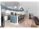 Open kitchen with white cabinets, granite countertops, a breakfast bar, and stainless steel appliances at 90 Hazelridge Ln, Sharpsburg, GA 30277