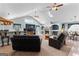 Open-concept living area with a fireplace, skylights, and bar seating, ideal for entertaining guests at 90 Hazelridge Ln, Sharpsburg, GA 30277