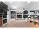 Cozy living room with a stone fireplace, built-in shelving, and ample natural light from the windows at 90 Hazelridge Ln, Sharpsburg, GA 30277
