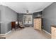 Carpeted bedroom featuring a ceiling fan, a window, and a sitting area near a vintage accent chair at 90 Hazelridge Ln, Sharpsburg, GA 30277