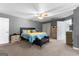 The main bedroom with carpet flooring, a ceiling fan, and a view of the en suite bathroom at 90 Hazelridge Ln, Sharpsburg, GA 30277
