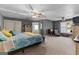 The main bedroom with cool grey walls and ample space, featuring a ceiling fan and sitting area at 90 Hazelridge Ln, Sharpsburg, GA 30277