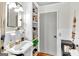 Bathroom featuring a pedestal sink, white tile, and convenient built-in shelving at 100 Cross Plains Hulett Rd, Carrollton, GA 30116