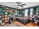 Cozy bedroom with built-in shelving, dark green walls, and a unique ceiling fan at 100 Cross Plains Hulett Rd, Carrollton, GA 30116