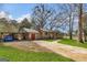 A house with a metal roof with lots of trees on a sunny day at 100 Cross Plains Hulett Rd, Carrollton, GA 30116