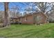 A house with a metal roof with lots of trees on a sunny day at 100 Cross Plains Hulett Rd, Carrollton, GA 30116