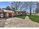 Charming brick home with a metal roof, spacious driveway, and sprawling front yard at 100 Cross Plains Hulett Rd, Carrollton, GA 30116