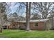 A house with a metal roof with lots of trees on a sunny day at 100 Cross Plains Hulett Rd, Carrollton, GA 30116