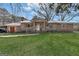 Charming brick home featuring a metal roof, shutters, and a lush green lawn at 100 Cross Plains Hulett Rd, Carrollton, GA 30116