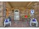 Inviting front porch with brickwork, decorated with plants and outdoor seating at 100 Cross Plains Hulett Rd, Carrollton, GA 30116