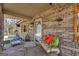 Cozy brick front porch with seating and decor, creating an inviting outdoor space at 100 Cross Plains Hulett Rd, Carrollton, GA 30116