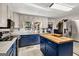 Modern kitchen with white cabinets, blue island, stainless steel appliances, and natural light at 100 Cross Plains Hulett Rd, Carrollton, GA 30116