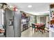 Spacious kitchen with tile flooring, stainless steel refrigerator, and a table with teal chairs at 100 Cross Plains Hulett Rd, Carrollton, GA 30116