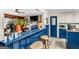 Open kitchen with blue breakfast bar overlooking the living room with a cozy fireplace at 100 Cross Plains Hulett Rd, Carrollton, GA 30116