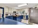 Kitchen featuring white and blue cabinets, tile flooring and an island with butcher block top at 100 Cross Plains Hulett Rd, Carrollton, GA 30116