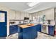 Bright kitchen with white upper cabinets, blue lower cabinets, and a central island with butcher block top at 100 Cross Plains Hulett Rd, Carrollton, GA 30116