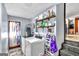 Well-equipped laundry area with modern appliances and ample storage space with wooden shelves at 100 Cross Plains Hulett Rd, Carrollton, GA 30116
