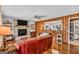 Inviting living room with hardwood floors, fireplace, and an open view into the kitchen and bathroom at 100 Cross Plains Hulett Rd, Carrollton, GA 30116
