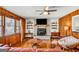 Bright living room featuring a brick fireplace, hardwood floors, and vintage decor at 100 Cross Plains Hulett Rd, Carrollton, GA 30116