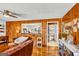 Inviting living room featuring wood-paneled walls, hardwood floors, and access to the bathroom at 100 Cross Plains Hulett Rd, Carrollton, GA 30116