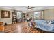 Charming bedroom featuring a ceiling fan, hardwood floors, and a large desk at 100 Cross Plains Hulett Rd, Carrollton, GA 30116
