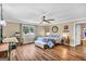 Comfortable primary bedroom featuring a ceiling fan, hardwood floors, and a large window at 100 Cross Plains Hulett Rd, Carrollton, GA 30116