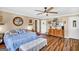 Cozy bedroom features hardwood floors, ceiling fan and large bed at 100 Cross Plains Hulett Rd, Carrollton, GA 30116