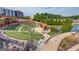 Scenic amphitheater view with lawn seating, a pond, and pedestrian walkways at 5808 Deer Crossing Dr, Sugar Hill, GA 30518