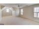 Large bedroom offers lots of carpeted space and two large windows for natural lighting at 5808 Deer Crossing Dr, Sugar Hill, GA 30518