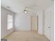 Neutral bedroom with carpet, a ceiling fan, and two closets, offers ample storage and comfort at 5808 Deer Crossing Dr, Sugar Hill, GA 30518