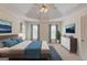 Main bedroom with ceiling fan and blue accents at 5808 Deer Crossing Dr, Sugar Hill, GA 30518