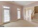 Spacious bonus room with plenty of natural light, carpeted floors, and access to the outside at 5808 Deer Crossing Dr, Sugar Hill, GA 30518