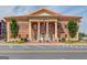 Elegant exterior elevation of City of Sugar Hill featuring brick facade, symmetrical design, and manicured landscaping at 5808 Deer Crossing Dr, Sugar Hill, GA 30518