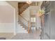 Grand foyer featuring a staircase with wood railings, tile flooring, and a view into other rooms at 5808 Deer Crossing Dr, Sugar Hill, GA 30518