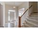 Bright foyer with tile flooring, stairway, and a clear view of the front door and surrounding rooms at 5808 Deer Crossing Dr, Sugar Hill, GA 30518