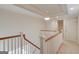 Hallway with carpeted floor and wooden railing at 5808 Deer Crossing Dr, Sugar Hill, GA 30518