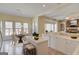 Bright kitchen with island, breakfast nook, and stone fireplace at 5808 Deer Crossing Dr, Sugar Hill, GA 30518