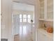 Bright eat-in kitchen features white cabinets and tile flooring at 5808 Deer Crossing Dr, Sugar Hill, GA 30518