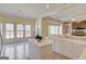 Bright kitchen with island, breakfast nook, and stone fireplace at 5808 Deer Crossing Dr, Sugar Hill, GA 30518