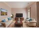 Cozy living room with a plush sofa, armchairs, a large TV, and stylish decor at 5808 Deer Crossing Dr, Sugar Hill, GA 30518