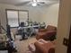A bedroom featuring red upholstered chairs, an ironing board and multiple exercise machines at 222 Farmbrook Pkwy, Stockbridge, GA 30281