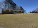 Traditional brick home featuring a well-maintained lawn and inviting front porch at 222 Farmbrook Pkwy, Stockbridge, GA 30281