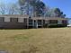 Traditional one-story home boasting a brick facade and well-kept front yard at 222 Farmbrook Pkwy, Stockbridge, GA 30281