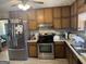 View of the eat-in kitchen featuring stainless steel appliances and wood cabinetry at 222 Farmbrook Pkwy, Stockbridge, GA 30281