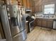 Eat-in kitchen features stainless steel appliances, wood cabinetry, and double bowl sink at 222 Farmbrook Pkwy, Stockbridge, GA 30281