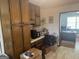 Spacious eat-in kitchen with custom wood cabinets and an adjacent doorway to the office at 222 Farmbrook Pkwy, Stockbridge, GA 30281