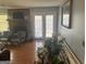 Bright living room featuring hardwood floors, a brick fireplace, and many plants at 222 Farmbrook Pkwy, Stockbridge, GA 30281