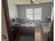 An office with a wooden desk, hardwood floors and a large window at 222 Farmbrook Pkwy, Stockbridge, GA 30281