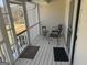 Cozy screened porch with comfortable seating, ideal for relaxation and enjoying the outdoors at 222 Farmbrook Pkwy, Stockbridge, GA 30281