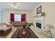 Comfortable living room featuring a fireplace, plush leather seating, and warm, neutral decor at 1475 Keystone Dr, Suwanee, GA 30024